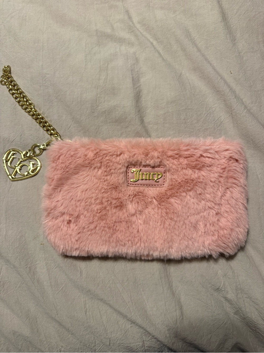Pink furry pouch - likely cosmetic bag